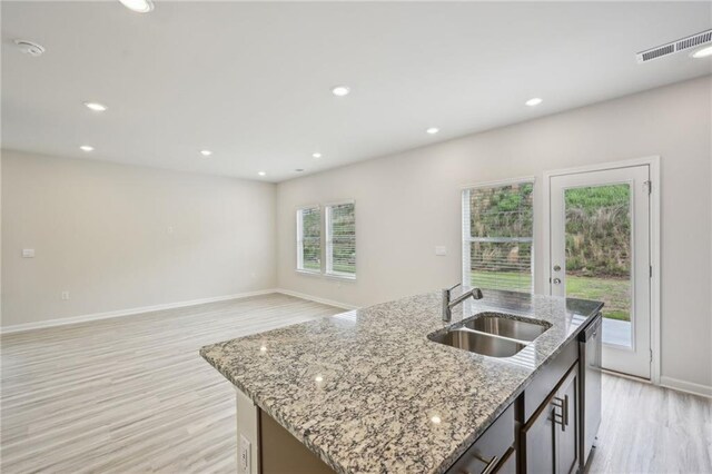 2770 Aralynn Way, College Park, GA 30337 - kitchen featuring stainless steel dishwasher, a kitchen island with sink, light wood-type flooring, a sink, and visible vents