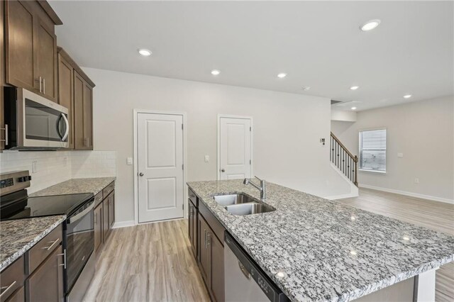 2770 Aralynn Way, College Park, GA 30337 - kitchen featuring stainless steel appliances, an island with sink, light wood finished floors, and a sink