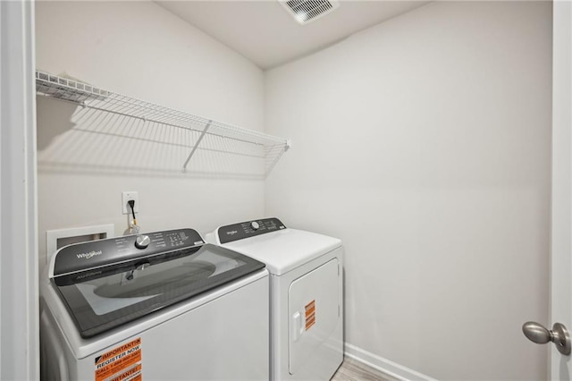 2770 Aralynn Way, College Park, GA 30337 - washroom featuring washer and dryer, visible vents, laundry area, and baseboards