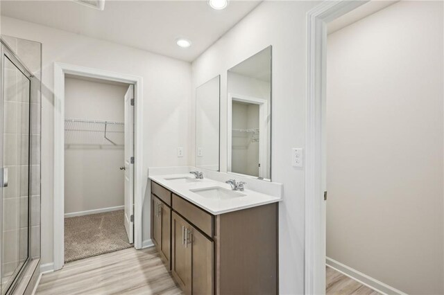 2770 Aralynn Way, College Park, GA 30337 - full bathroom featuring a walk in closet, a stall shower, and a sink