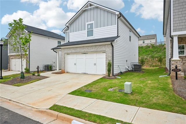 2770 Aralynn Way, College Park, GA 30337 - view of front of property featuring a front yard, an attached garage, board and batten siding, and central AC unit