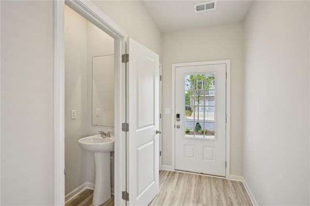 2770 Aralynn Way, College Park, GA 30337 - doorway to outside featuring visible vents, light wood-type flooring, and baseboards