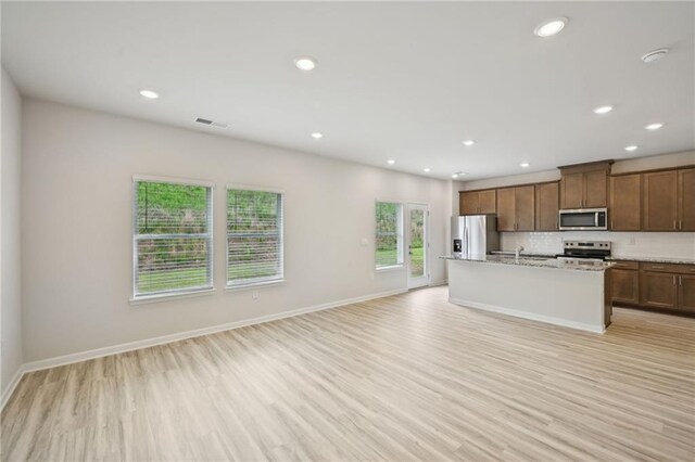 2770 Aralynn Way, College Park, GA 30337 - kitchen with open floor plan, light wood-style floors, stainless steel appliances, and decorative backsplash