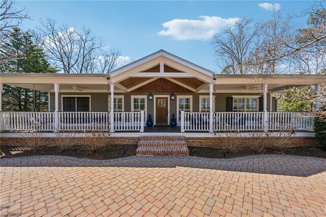 wooden deck featuring outdoor dining space and a porch