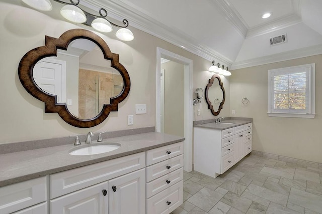 bathroom with vanity, crown molding, and vaulted ceiling