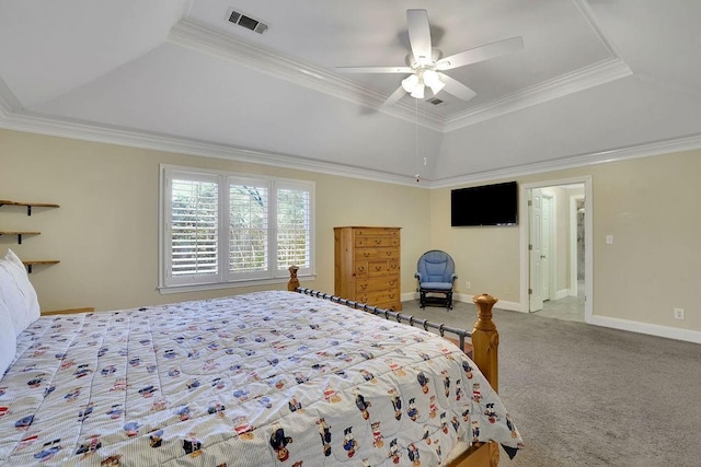 carpeted bedroom featuring a tray ceiling, ceiling fan, and ornamental molding