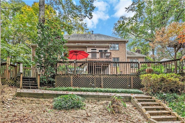 rear view of house with a wooden deck