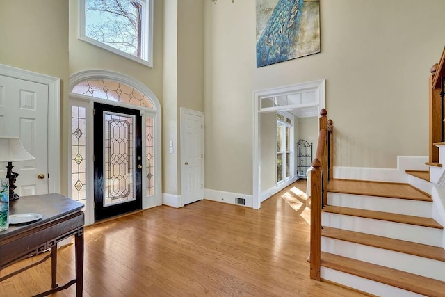 entrance foyer with a high ceiling and light hardwood / wood-style flooring