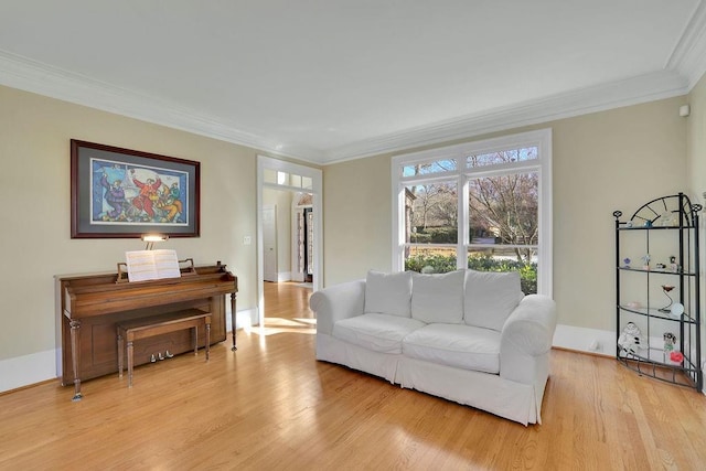 living room with light wood-type flooring and crown molding