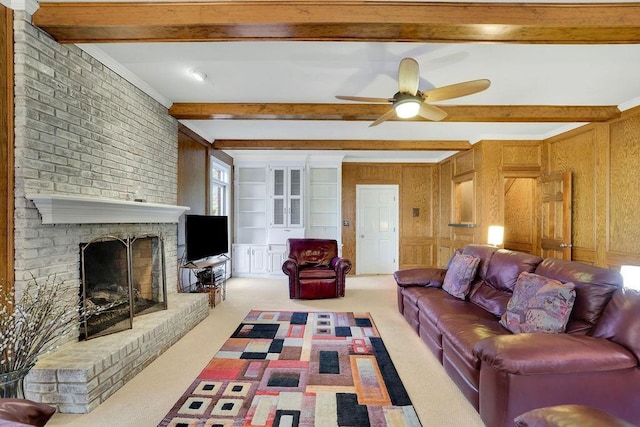 living room featuring beamed ceiling, carpet, wooden walls, and a brick fireplace