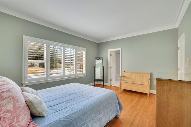 bedroom with light hardwood / wood-style flooring and crown molding