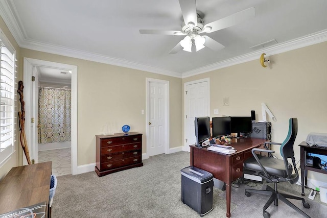 carpeted home office featuring ceiling fan and crown molding