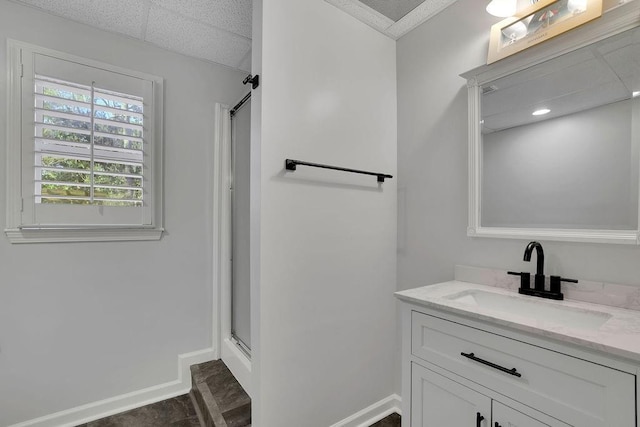 bathroom with a shower with door and vanity