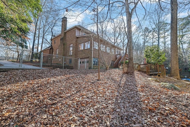 rear view of property featuring a deck