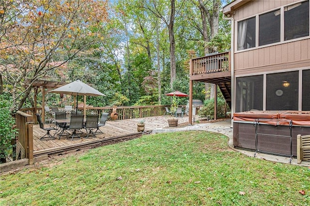 view of yard with a sunroom, a deck, and a hot tub