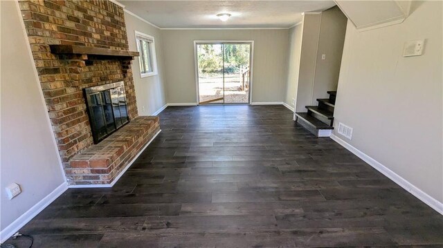 unfurnished living room featuring a fireplace, ornamental molding, and dark wood-type flooring