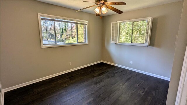 empty room with dark hardwood / wood-style floors and ceiling fan