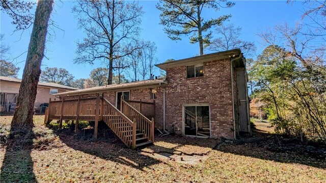 back of property featuring a wooden deck