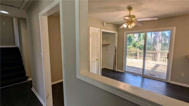 interior space with ceiling fan and dark hardwood / wood-style flooring