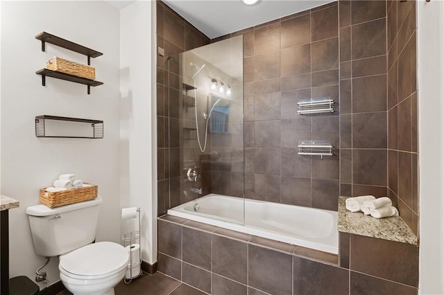 bathroom featuring toilet and tiled shower / bath combo