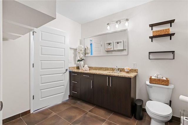 bathroom with vanity, tile patterned floors, and toilet