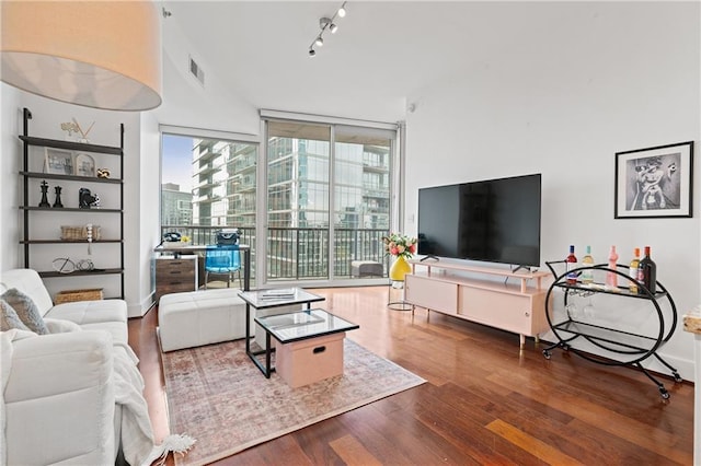 living room with hardwood / wood-style flooring, floor to ceiling windows, and rail lighting