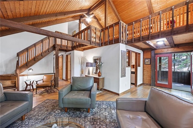 living room with high vaulted ceiling, light wood-type flooring, beam ceiling, wooden ceiling, and ceiling fan