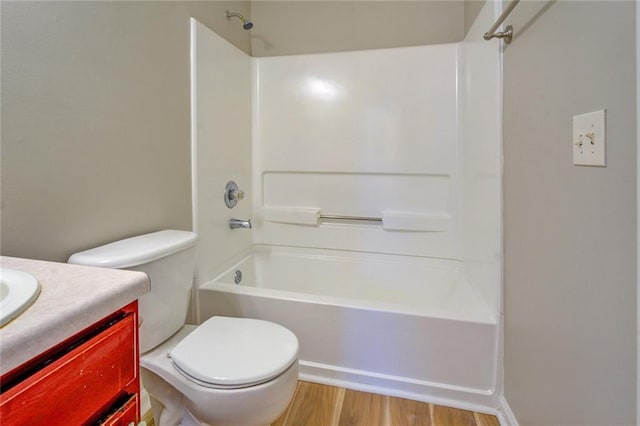 full bathroom with hardwood / wood-style floors, vanity, toilet, and shower / bathing tub combination