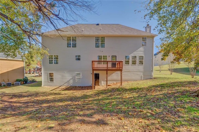 back of property featuring central air condition unit, a wooden deck, and a lawn