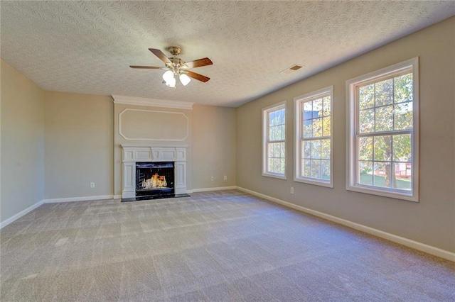 unfurnished living room featuring light carpet, a textured ceiling, and ceiling fan