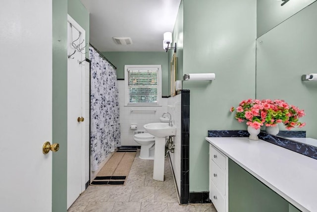 2648 Oswood Dr, Tucker, GA 30084 - full bath with tile walls, curtained shower, tile patterned floors, toilet, and a sink