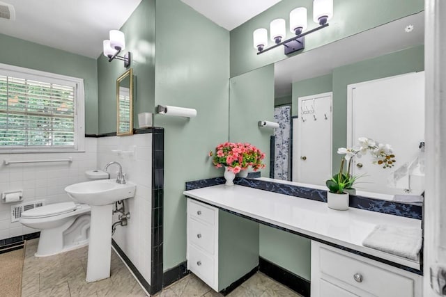 2648 Oswood Dr, Tucker, GA 30084 - bathroom featuring toilet, tile walls, and a sink
