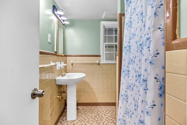 2648 Oswood Dr, Tucker, GA 30084 - bathroom with tile walls, a shower with shower curtain, wainscoting, and a sink