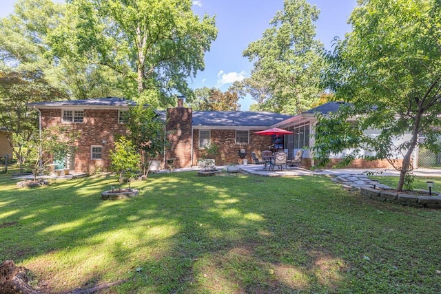 2648 Oswood Dr, Tucker, GA 30084 - rear view of property with brick siding, a patio, a chimney, and a yard