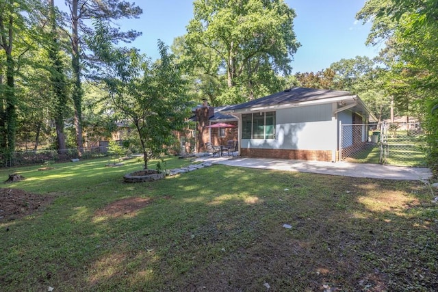 2648 Oswood Dr, Tucker, GA 30084 - rear view of house with a gate, a patio, a chimney, and brick siding