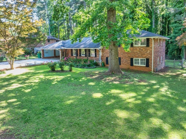 2648 Oswood Dr, Tucker, GA 30084 - view of front of home with driveway, brick siding, and an attached carport