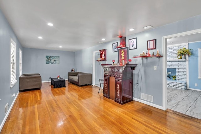 2648 Oswood Dr, Tucker, GA 30084 - living room with baseboards, recessed lighting, wood finished floors, a brick fireplace, and bar
