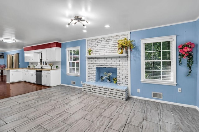 2648 Oswood Dr, Tucker, GA 30084 - kitchen with dishwasher, baseboards, white cabinets, a sink, and crown molding