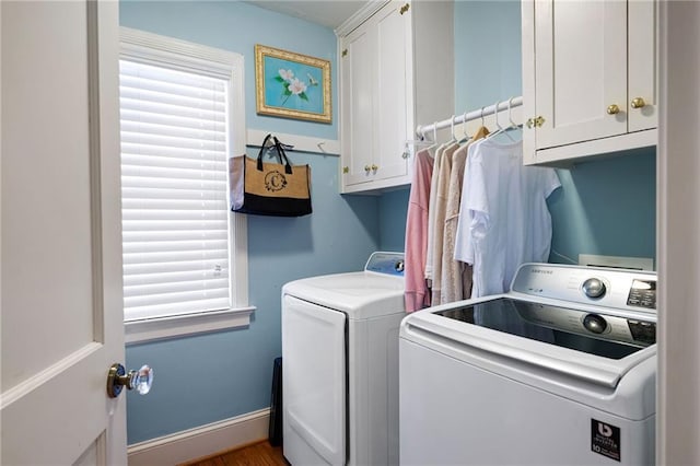 washroom with cabinet space, baseboards, a wealth of natural light, and independent washer and dryer