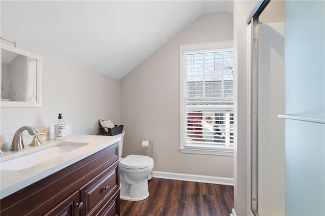 full bathroom with a stall shower, a wealth of natural light, lofted ceiling, and wood finished floors