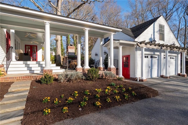 view of front of home featuring driveway, ceiling fan, a porch, and an attached garage