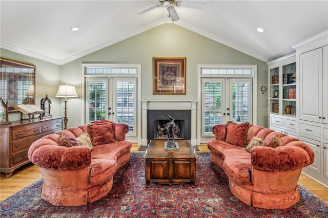 living room with french doors, a healthy amount of sunlight, and crown molding