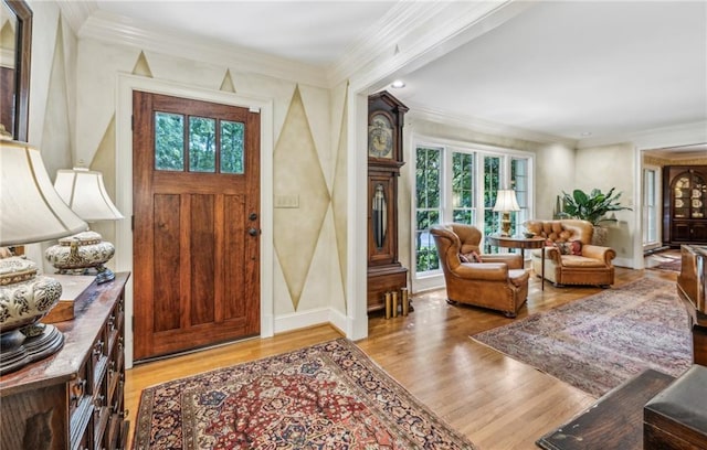 entrance foyer featuring light hardwood / wood-style floors, crown molding, and plenty of natural light