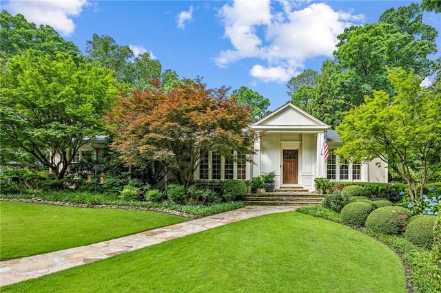 neoclassical home featuring a front yard