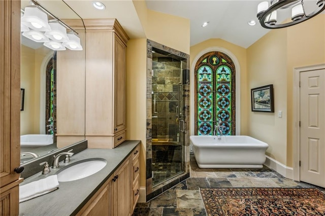 bathroom featuring separate shower and tub, lofted ceiling, and vanity