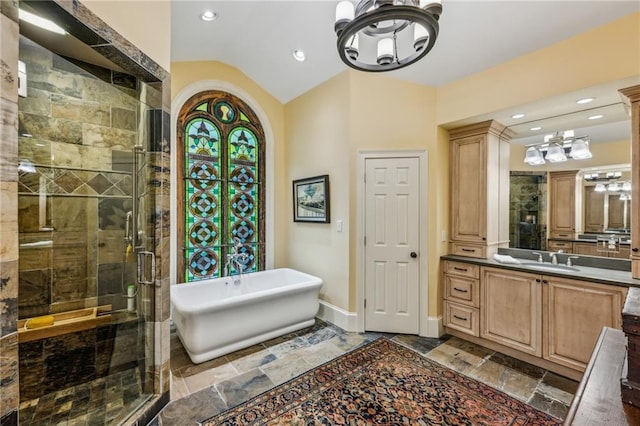 bathroom featuring independent shower and bath, lofted ceiling, and vanity