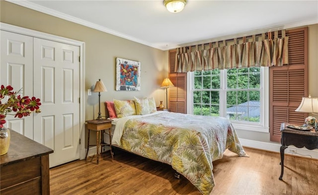 bedroom featuring ornamental molding and hardwood / wood-style flooring