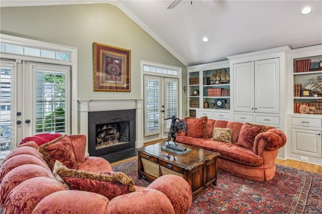 living room with french doors, lofted ceiling, crown molding, ceiling fan, and wood-type flooring