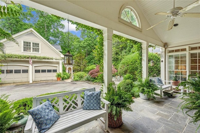 sunroom / solarium with lofted ceiling and ceiling fan