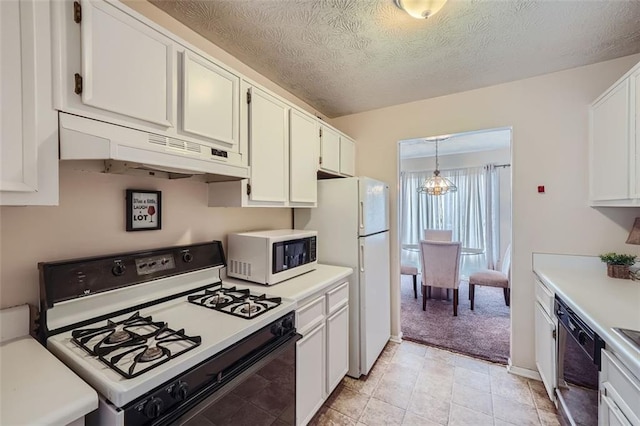 kitchen with white appliances, a textured ceiling, a chandelier, white cabinetry, and pendant lighting